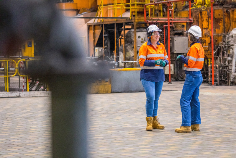 Two women chatting at one of our power generation facilities