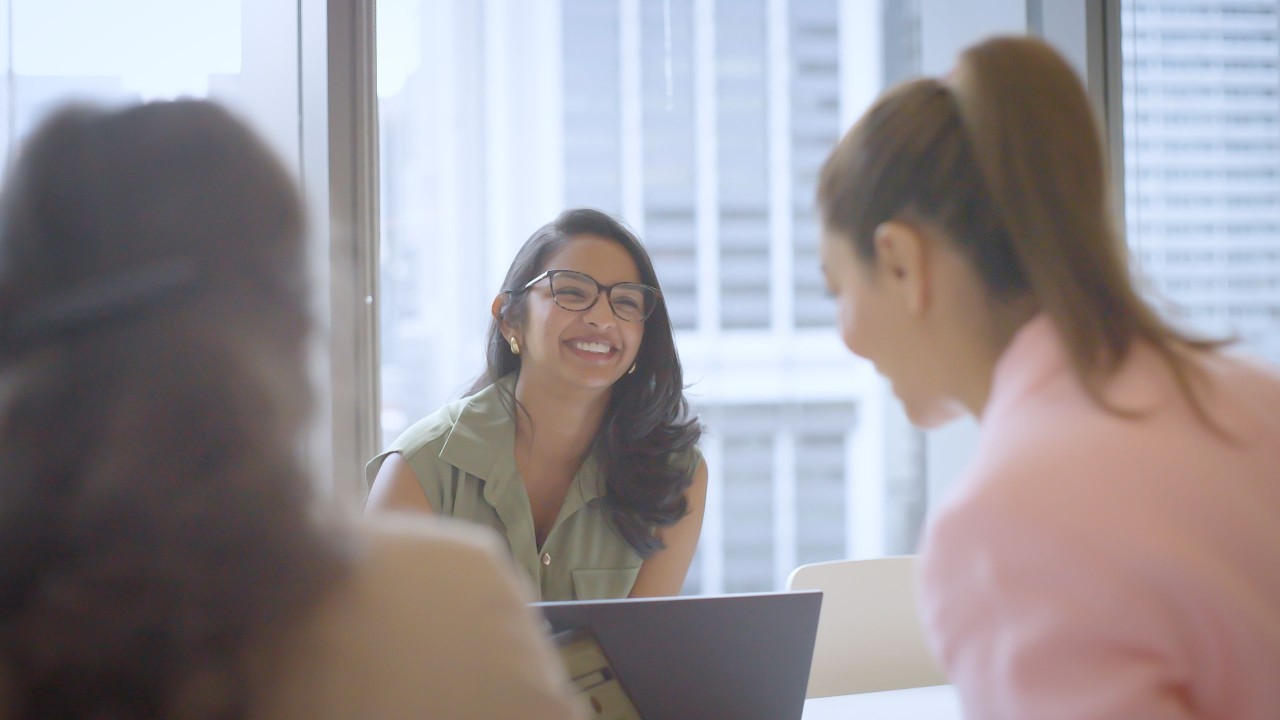 AGL team members chatting in the office