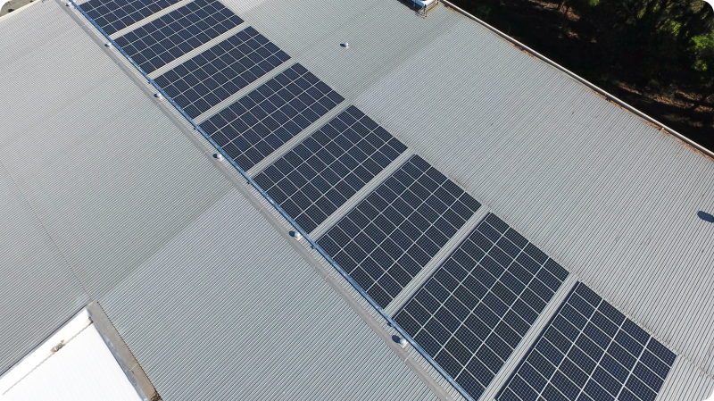 Aerial shot of a chocolate factory with solar panels on the roof