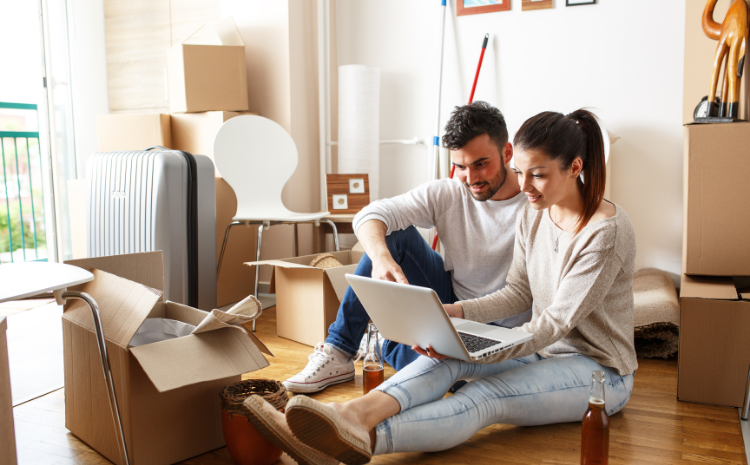 Couple on laptop in the middle of a move