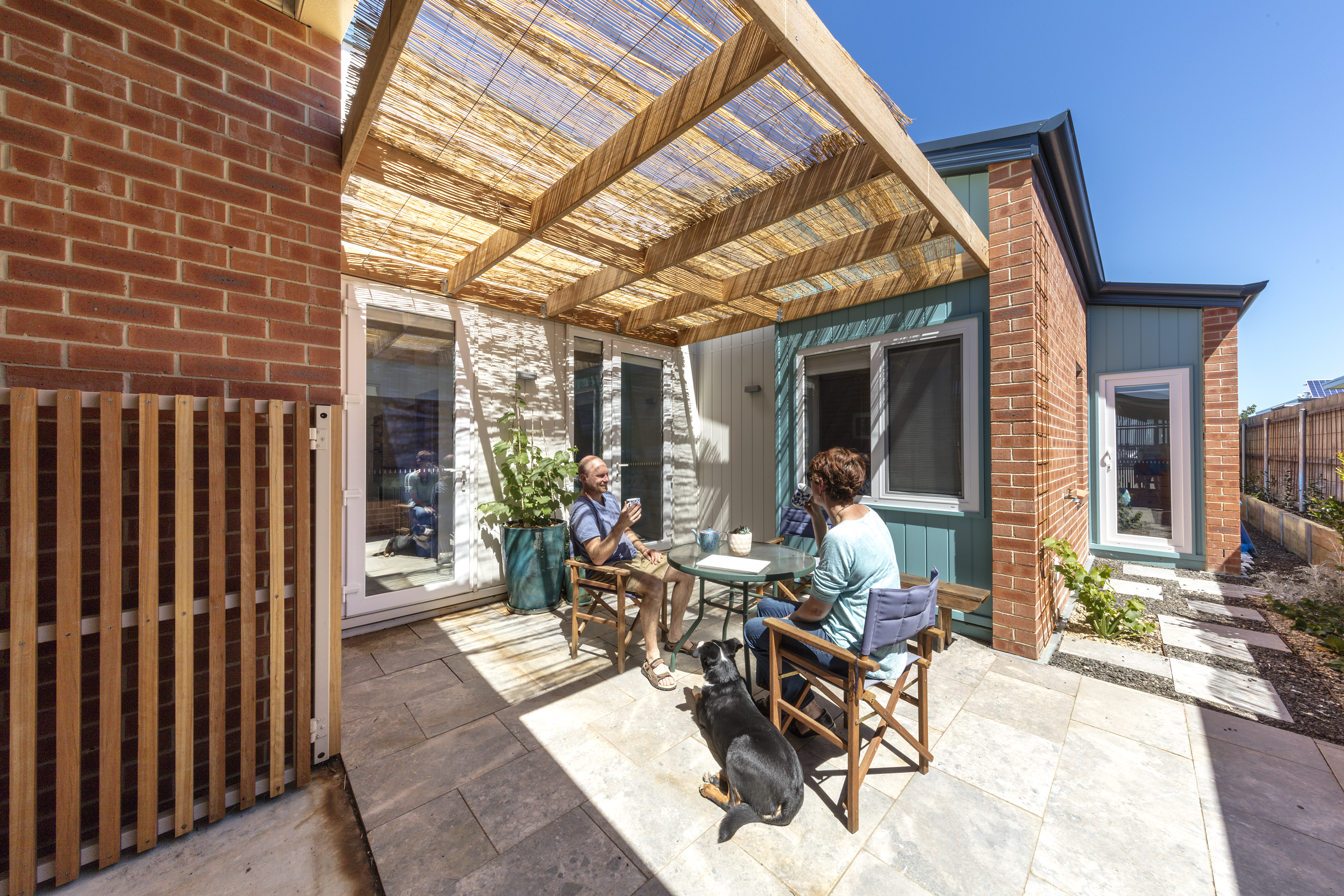 Older couple sitting on outdoor deck in summer