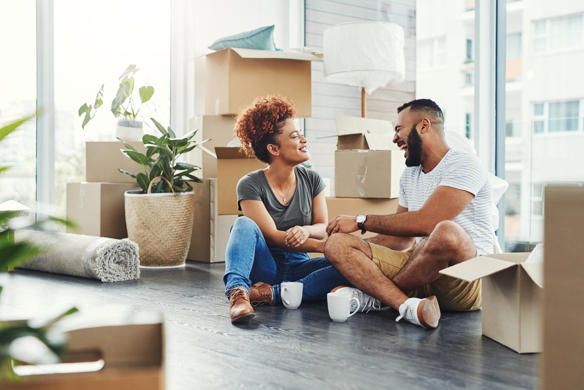A couple unpacking their boxes in their new home