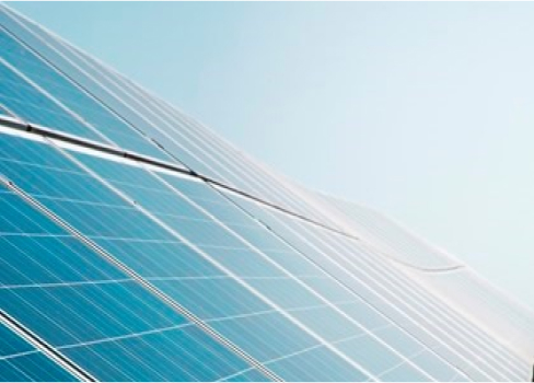 Close up of a solar panel array with the sun reflecting off it