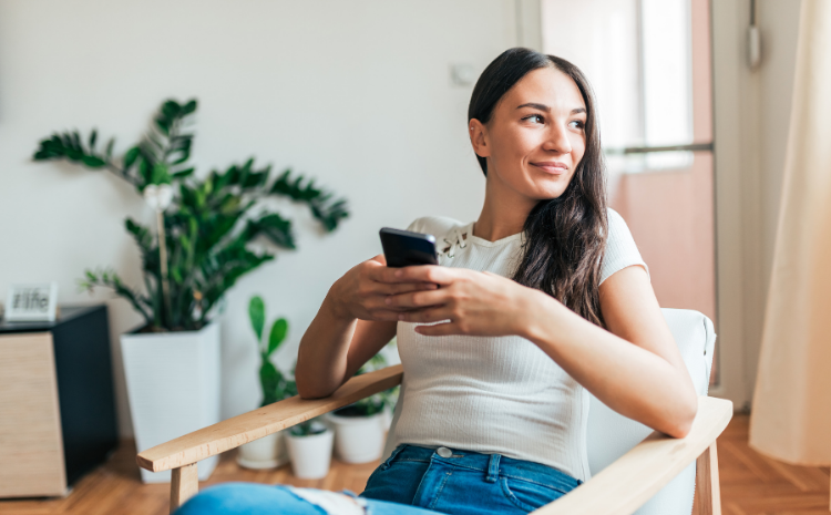 Lady using phone on chair