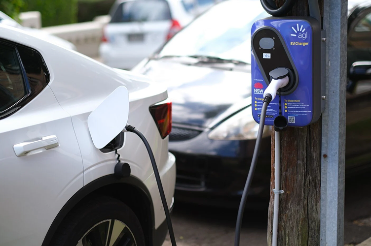 An EV plugged into an AGL branded public charger